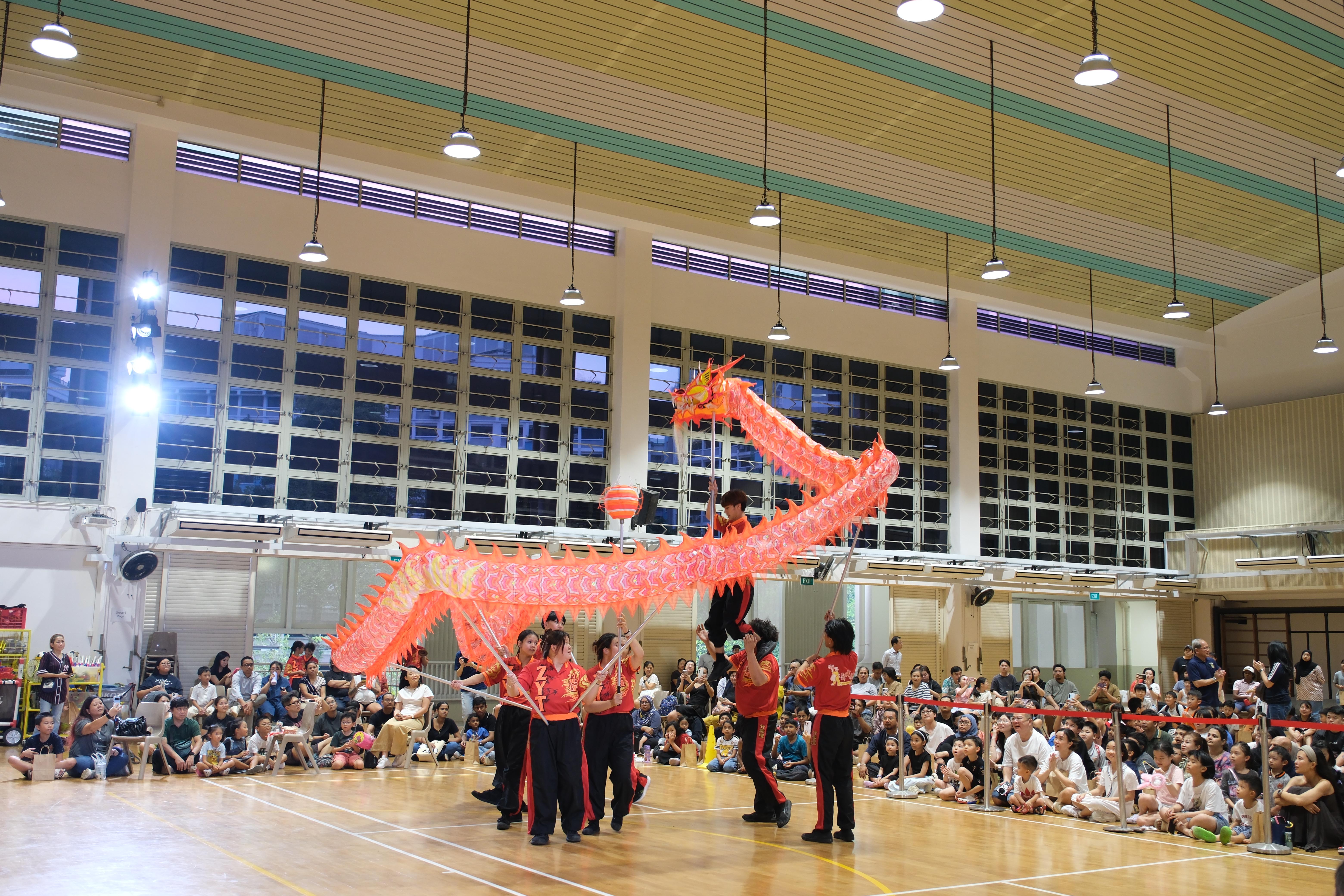 The spectacular dragon dance thrills families and fills the hall with excitement.